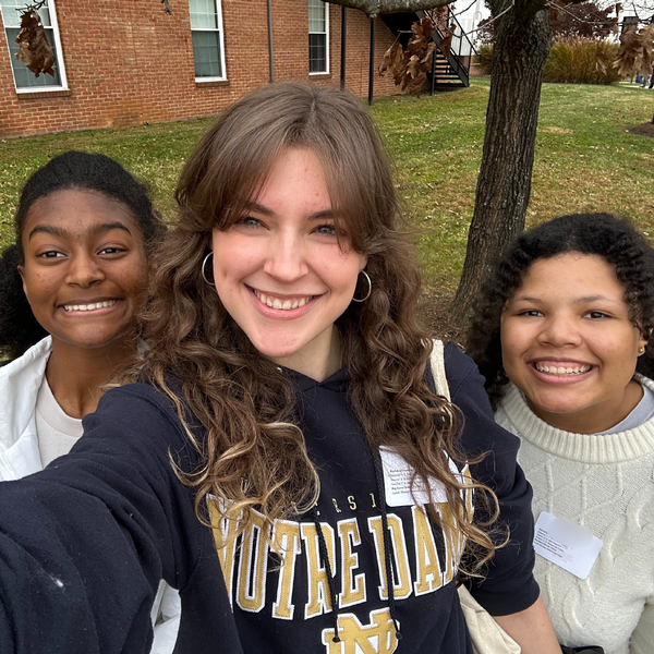Three seniors from The Siena School smile proudly in a selfie taken outdoors while attending a student diversity leadership conference.