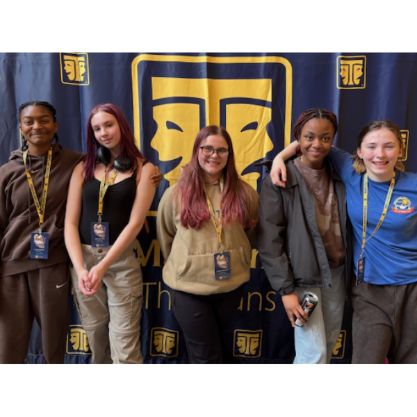 Five high school girls smile happily at the camera while at a statewide theatre festival in Maryland.