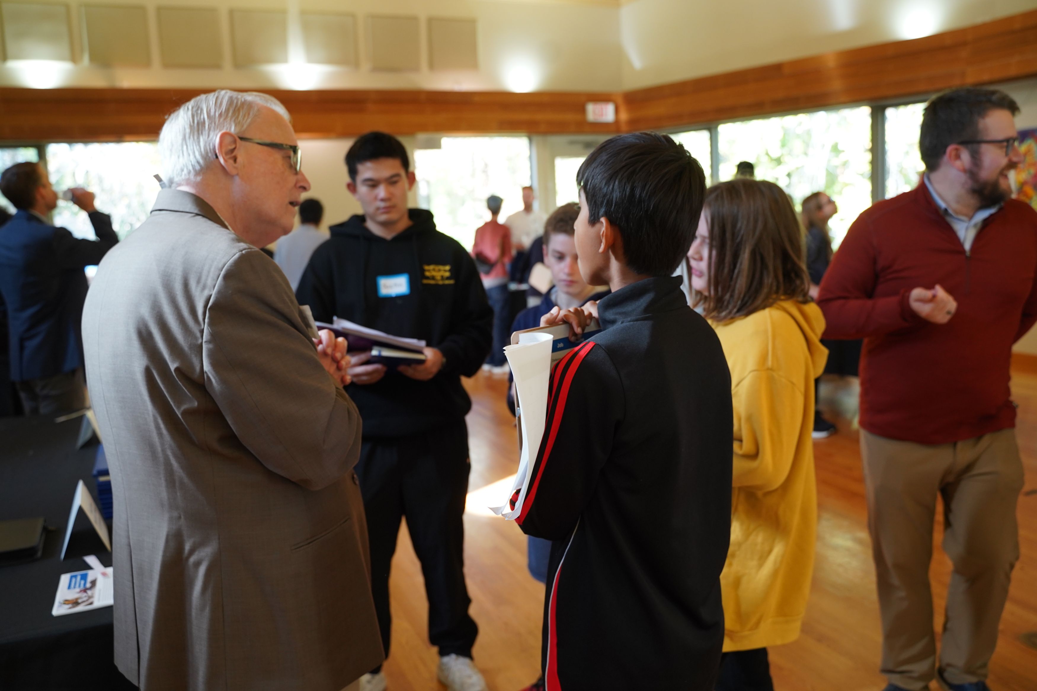 Students and career representatives are in a large room during a Career Fair.