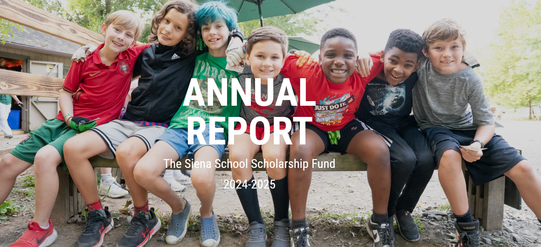 Seven boys with their arms around each other smile at the camera, with the words ANNUAL REPORT in white as text overlay.